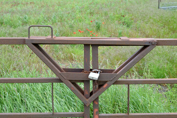Modern Steel Farm Field Gate with Padlock in Close Up 