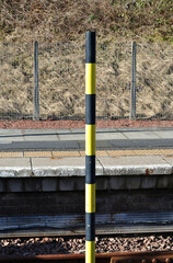 Platform Edge with Black and Yellow Warning Pole at End of Railway Line in Railway Station