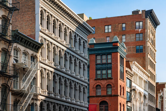 Historic cast iron buildings with ornate facades and fire escapes in SoHo Historic District, Manhattan. Architectural detail along Broadway in New York City, USA