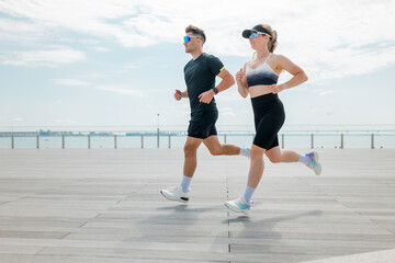 Running along the waterfront path at sunrise with friends