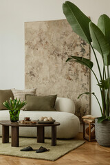 Naklejka na ściany i meble Cozy living room with neutral furniture, green accents, and large tropical plant. Earthy textures meet modern calm.