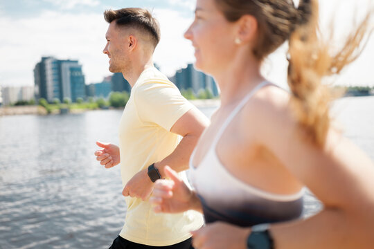 Jogging by the waterfront with friends on a sunny day