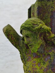 green moss on jesus sculpture