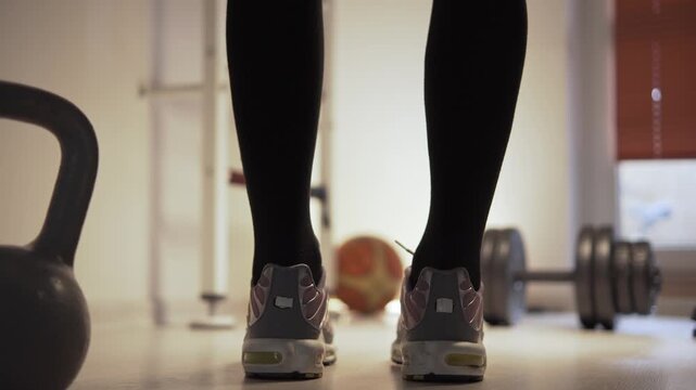 Athlete leans forward, touches flore with his hands, stretching, warming up