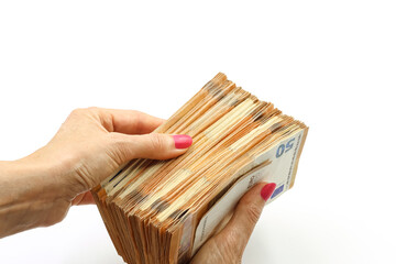 Woman's hand holding a bundle of 50 euro bills. Space for text.