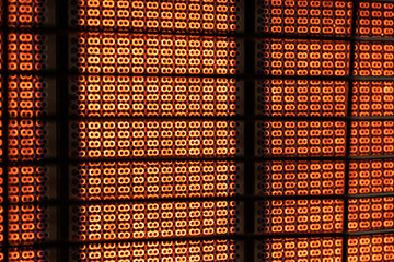 A close-up of a glowing heater element, radiating warmth and light