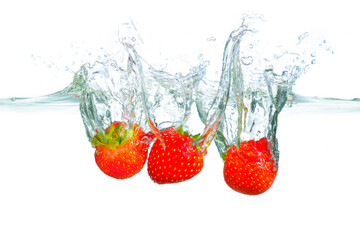 Fresh Strawberries Splashing in Clear Water with Bubbles and Ripples