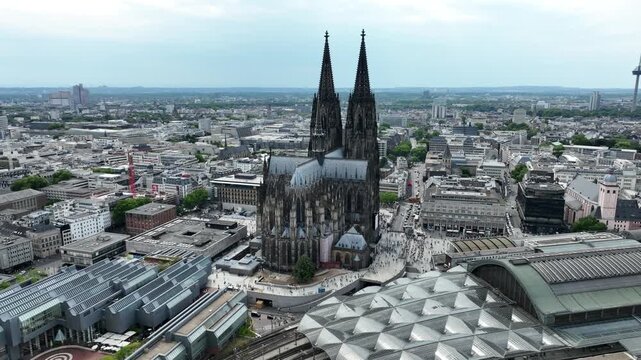 Cathedral in Cologne City, Germany. Central Train Station, Hbf in background. Drone