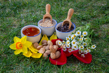 Colorful Display of Natural Foods and Blossoms on a Grassy Background