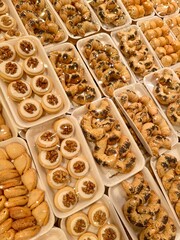 small sets of beautiful homemade cookies on an individual plastic backing in the supermarket. packing cookies in the supermarket.