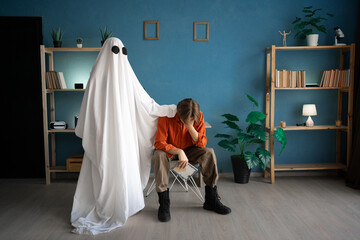 Concept of afterlife and memory for lost love. Depressed sad widower crying holding old photo while...