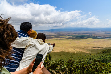 View of the Ngorongoro crater in Tanzania. Ngorongoro conservation area. African landscape. Guide showing something to tourists © ihorbondarenko