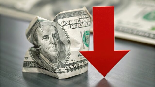 Crumpled dollar bill with a red downward arrow, symbolizing financial decline or loss. - Powered by Adobe