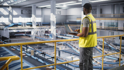 Black Employee Working at a Modern Logistics Center for an International Online Shopping Business....