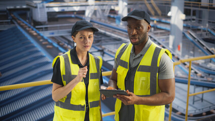 Delivery Station Warehouse Associates Having a Conversation at a Modern Logistics Center. Workers Using Tablet to Manage the Automated Conveyor Belt Load, Prepare Online Shopping Orders for Delivery