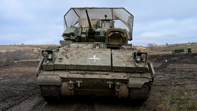 This M2 Bradley IFV serves a dual role in Ukraine's army. The medical cross marks it for casualty evacuation (CASEVAC), while cage armor is vital for surviving drone warfare.