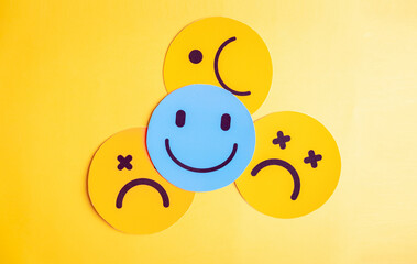 Emotional state and mental wellness. Smiley face by multiple sad expressions showing mood variation and contrast. Useful for psychology, emotion tracking, and mental health themes.