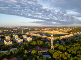 Great Strahov Stadium, surrounded by lush greenery, showcases its vastness during sunset in Prague....