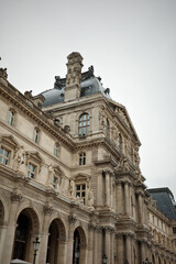 Historic Exterior of the Louvre Museum with Dome and Sculptures