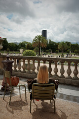 Woman Relaxing in Jardin du Luxembourg with City View in Paris