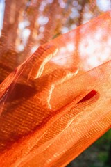 Abstract Orange Fabric with Hand Reaching for Light, Ethereal and Dreamlike Texture.