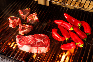 Juicy steaks and bell peppers sizzling on a grill