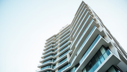 Architectural Waves Striking Modern Building Featuring Curving Lines and Reflective Glass Against a Bright and Expansive Sky