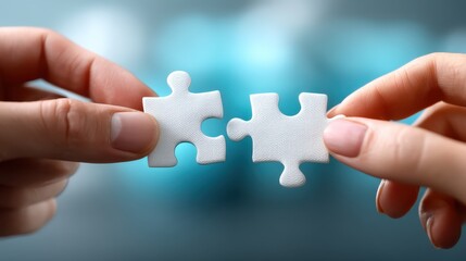Hands connecting puzzle pieces on blue blurred background