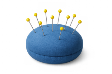 Vintage blue pincushion securing pins with bright yellow heads, standing against transparent backdrop for crafting and sewing needs