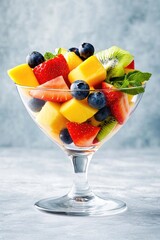 Refreshing fruit salad with strawberries, kiwi, and mango in a glass bowl
