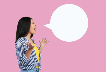 Portrait of emotional asian woman screaming at blank speech bubble. Free place for your text, lady...