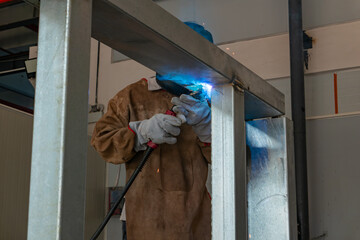 worker welding in a factory at horizonal composition
