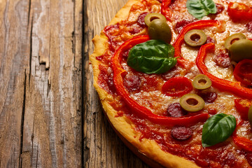 Delicious pizza served on wooden plate