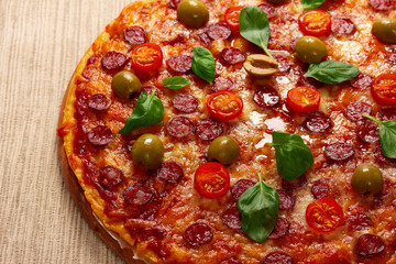 Delicious pizza served on wooden plate