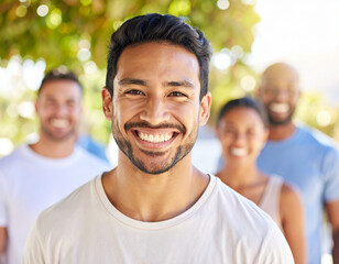 Four casually dressed friends stand together in a sunlit park, surrounded by lush greenery and trees. Capturing a moment of connection and natural light, the image evokes warmth and togetherness