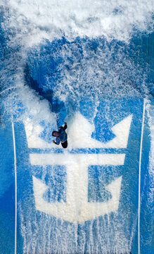 Aerial view of a person surfing on a flowrider with the Royal Caribbean logo beneath the water, Split, Split-Dalmatia County, Croatia.