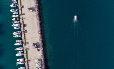 Aerial view of boats docked along the Riva Harbor with deep blue waters contrasting the bright white vessels, Split, Split-Dalmatia County, Croatia.