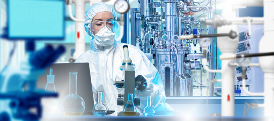 Scientist in protective suit works with microscope and bioreactor equipment in sterile lab,...
