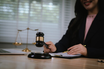 Attractive young lawyer in office Business woman and lawyers discussing contract papers with brass...