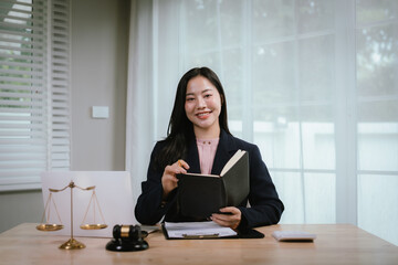 Attractive young lawyer in office Business woman and lawyers discussing contract papers with brass...