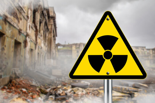 Radiation warning sign in front of a ruined, abandoned building with smoke and debris, symbolizing danger, contamination, or nuclear disaster. Nuclear hazard, disaster zone.