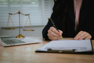 A lawyer consulting with a client in an office, reviewing legal documents and contracts related to...