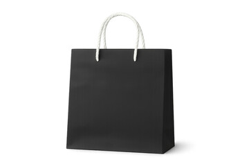 Black shopping bag featuring white rope handles, photographed in studio setting against transparent background, symbolizing retail consumer culture