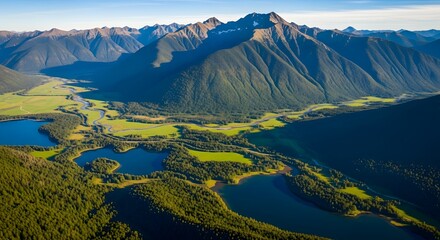 Aerial view of winding river and lakes in green valley between mountains