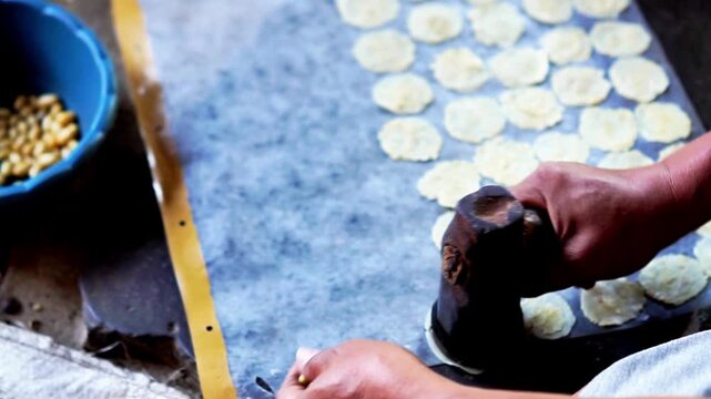 The process of making emping melinjo (melinjo chips). It tastes a little bitter and very tasty. Melinjo is also known as Gnetum gnemon
