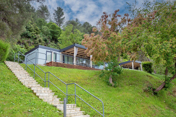 Premium mobile home with glass terrace in forest.