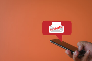 A mobile security,Cybersecurity concept. A scam alert notification on a smartphone screen, warning the user of a potential phishing attack, malware, or virus. Online threat protection for devices.