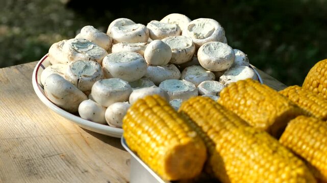Champignons filled with cheese, corn mais for summer barbecue, bbq evening, cooking outside on grill