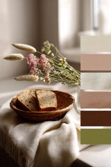 Fototapeta premium Still life photography featuring a wooden bowl with bread, flowers, and a neutral color palette display alongside it