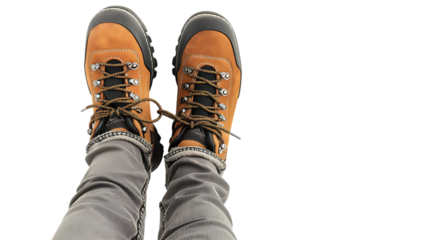 A view from above showcasing brown leather boots with laces tied together and gray denim jeans